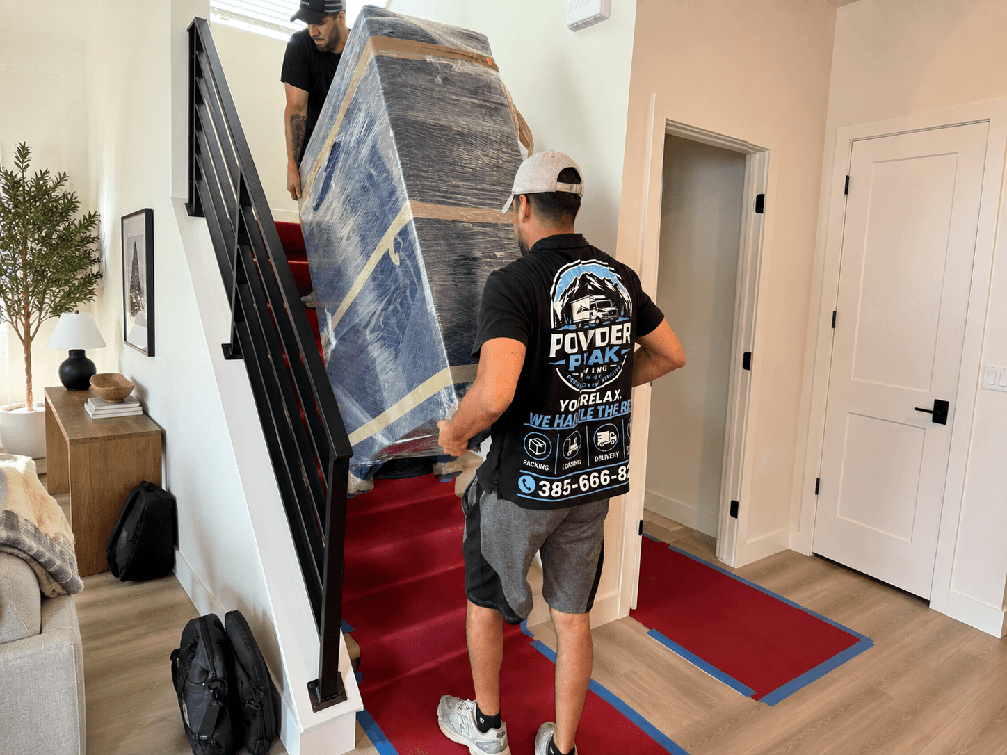 Powder Peak Moving professionals loading protected furniture